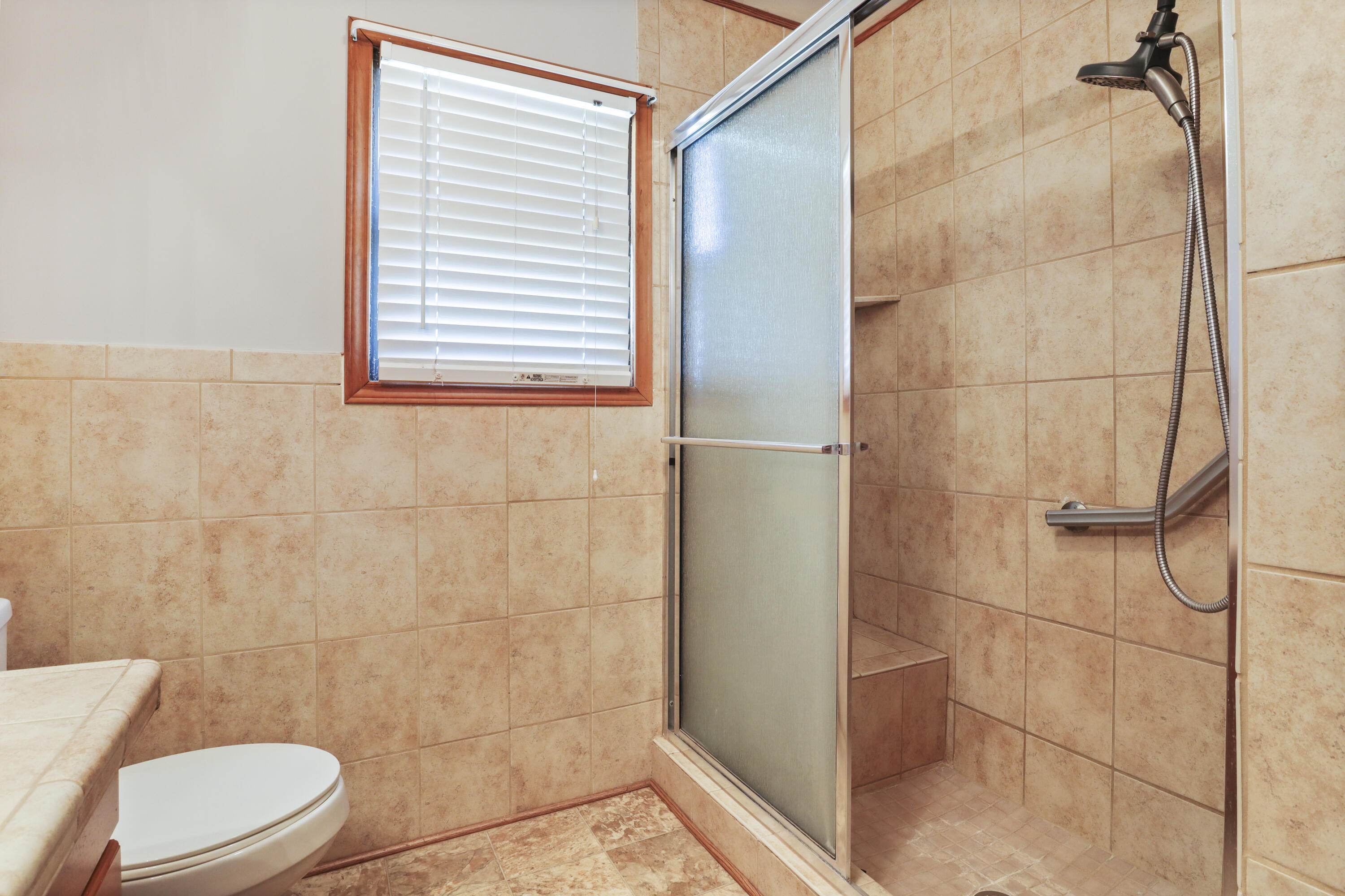 511 6th Street Wolfforth, TX 79382 - Photo 19 of 26 a bathroom with a toilet and a shower
