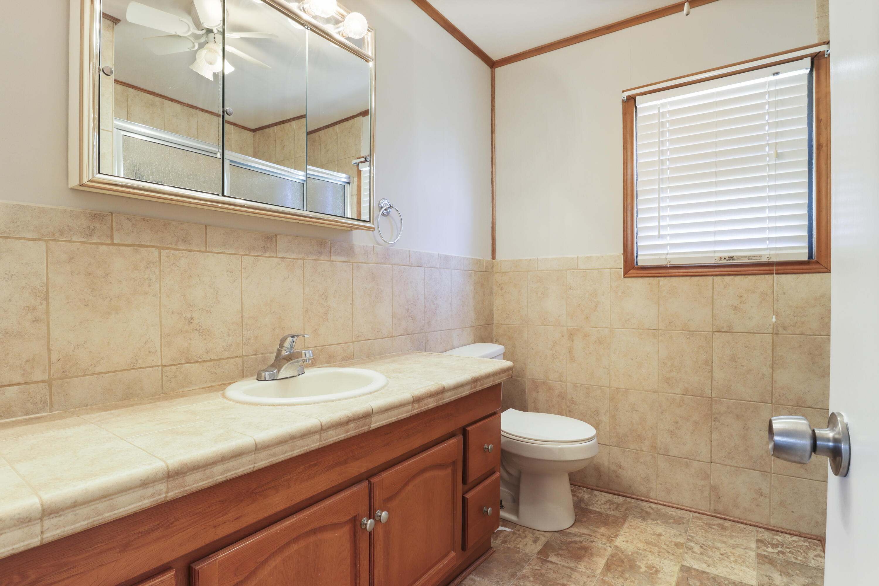 511 6th Street Wolfforth, TX 79382 - Photo 20 of 26 a bathroom with a sink a toilet and a mirror