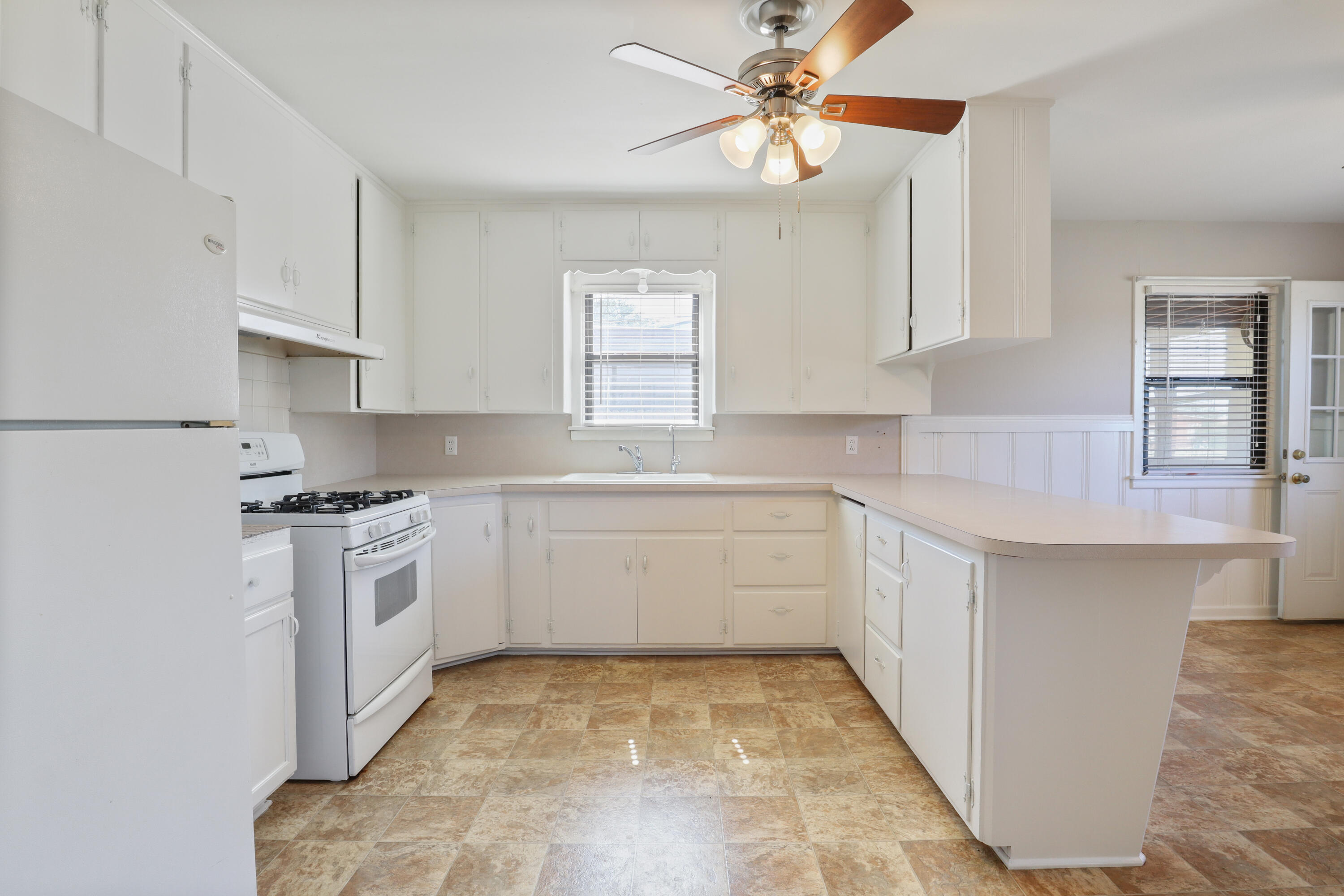 511 6th Street Wolfforth, TX 79382 - Photo 5 of 26 a kitchen with a stove a sink and a refrigerator