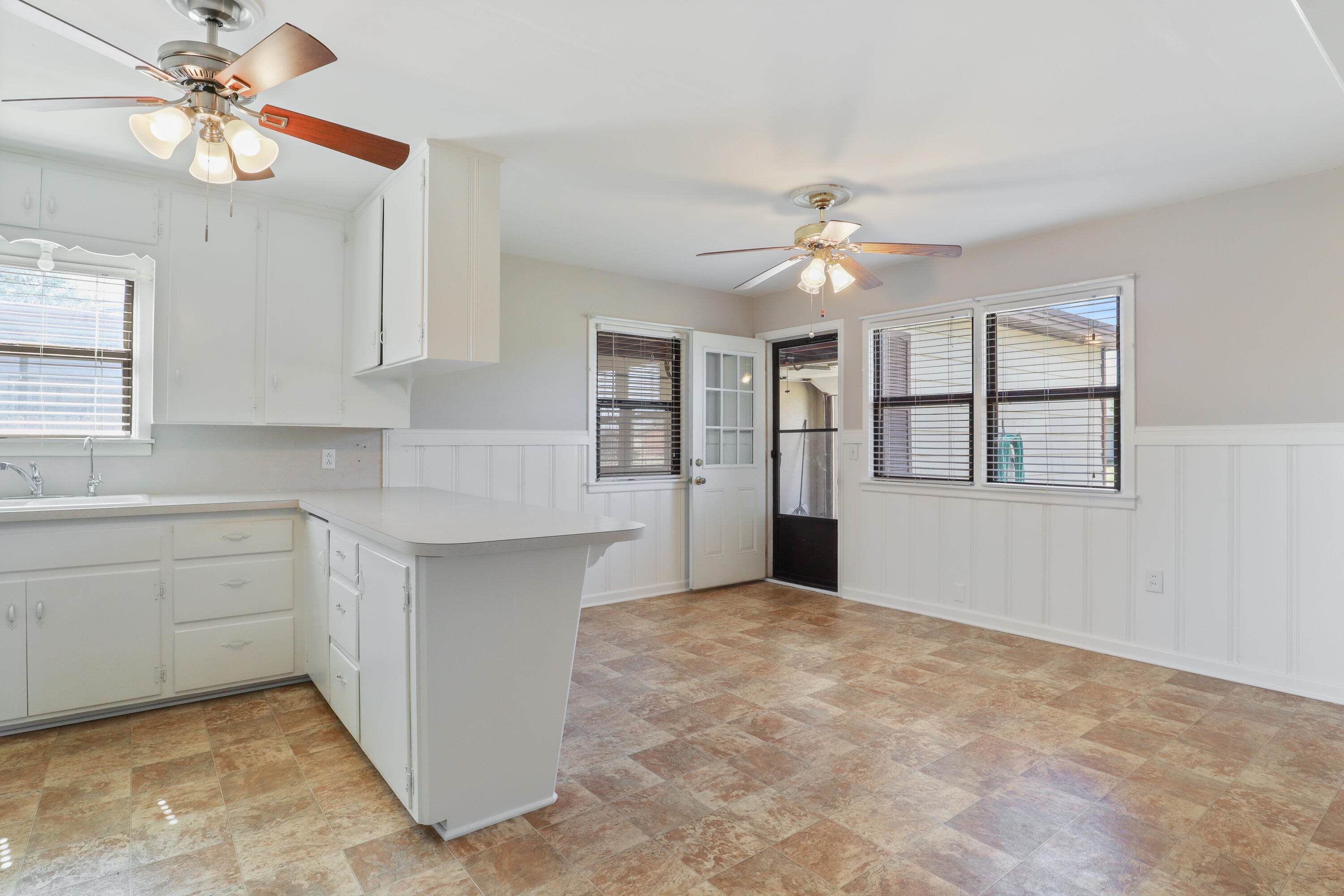 511 6th Street Wolfforth, TX 79382 - Photo 8 of 26 a kitchen with kitchen island white cabinets and window