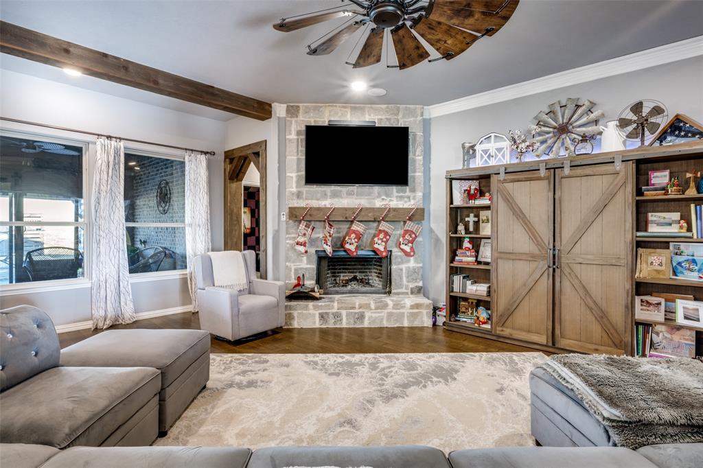 7417 Green Mesa Road Ponder, TX 76259 - Photo 6 of 39 a living room with furniture a flat screen tv and a fireplace