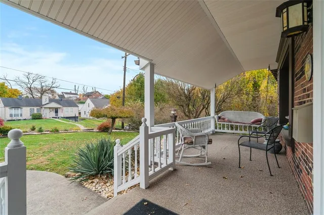 a balcony with table and chairs