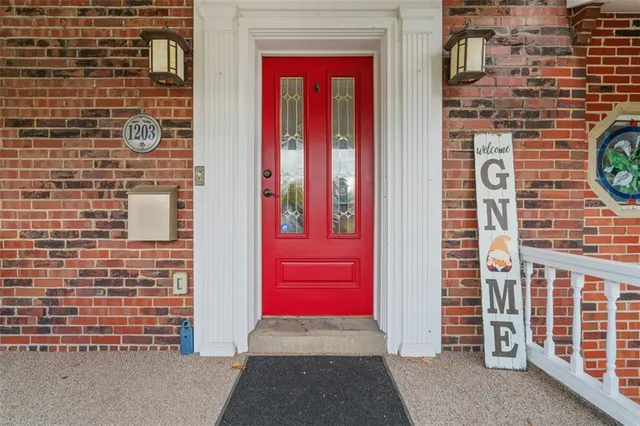 a view of a door and brick walls