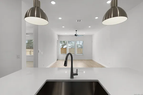a kitchen with a sink and chandelier