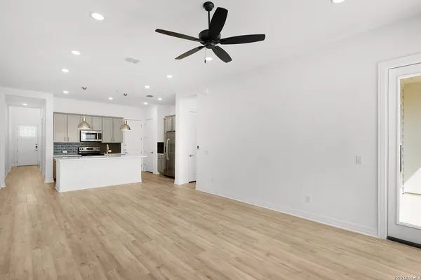 a view of kitchen with stainless steel appliances kitchen island sink and refrigerator