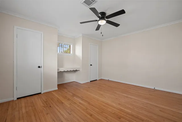 a view of empty room with wooden floor