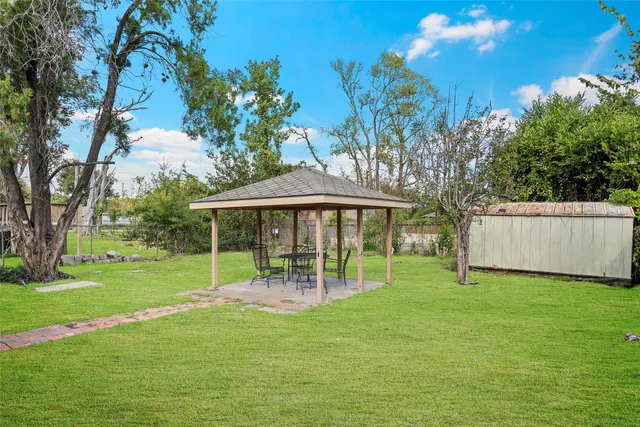 a backyard of a house with table and chairs