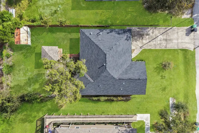 an aerial view of a house with a yard