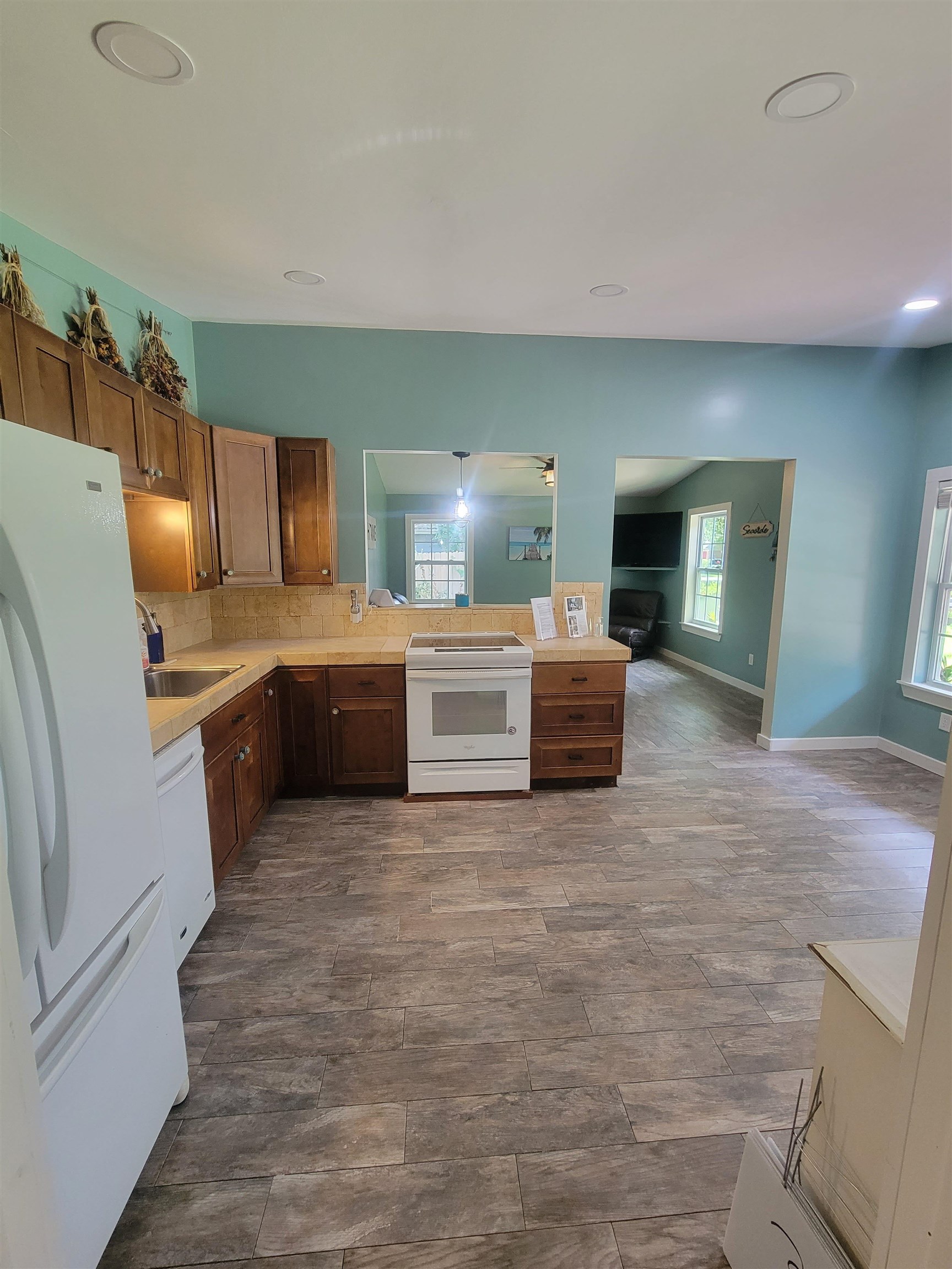 203 Queen Road St. Augustine, FL 32086 - Photo 5 of 32 a large kitchen with a stove a sink and a refrigerator