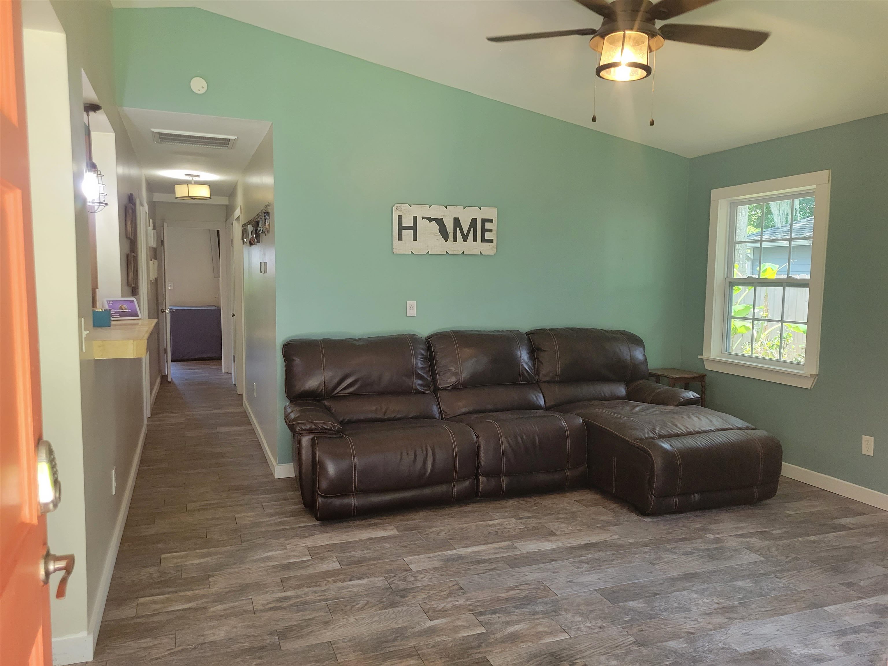 203 Queen Road St. Augustine, FL 32086 - Photo 8 of 32 a living room with furniture and a chandelier