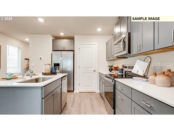 a kitchen with a sink stainless steel appliances and cabinets