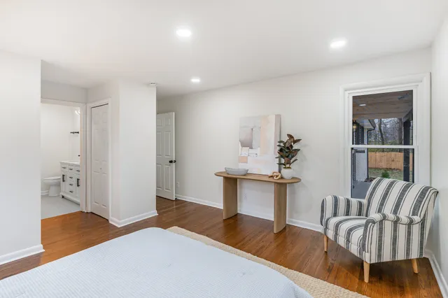 a bedroom with furniture and a wooden floor