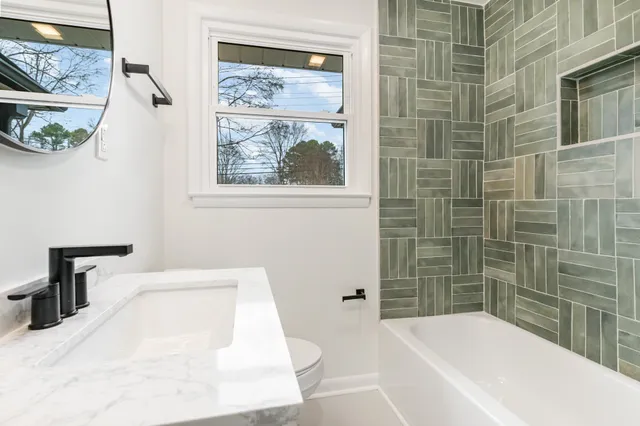 a bathroom with a bathtub and shower
