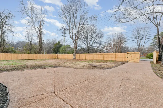 a view of a yard with large trees