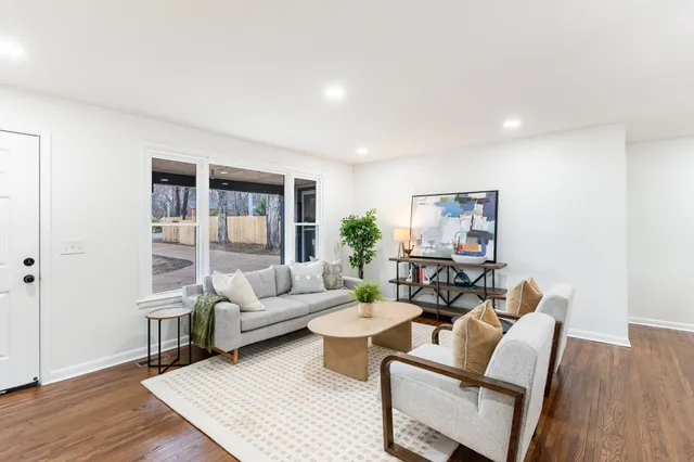 a living room with furniture and wooden floor