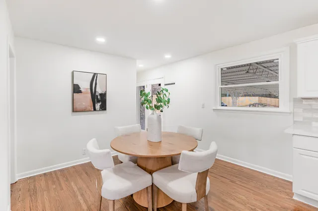 a dining room with furniture and wooden floor