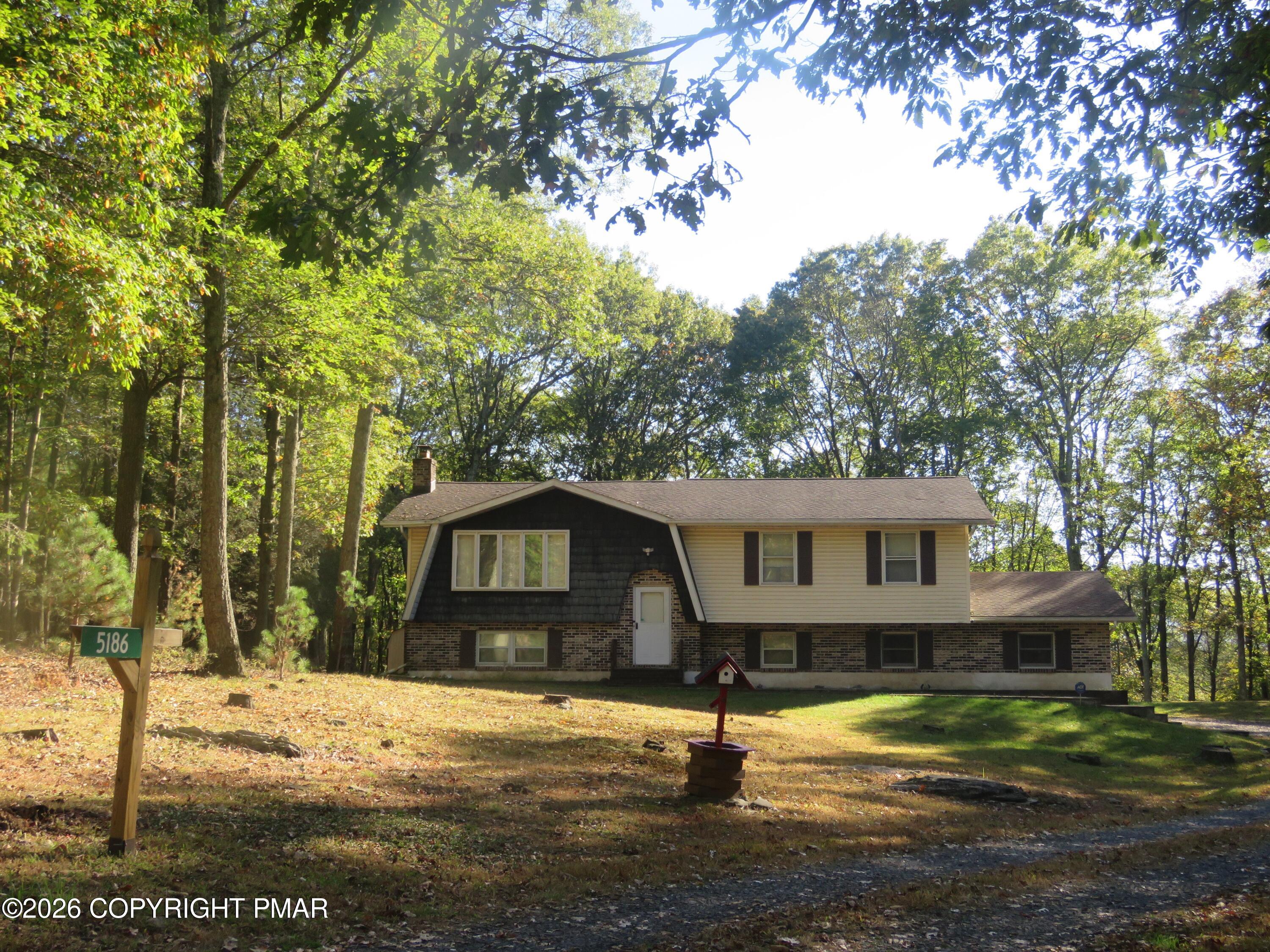 5186 Spring Drive Swiftwater, PA 18370 - Photo 22 of 22 a front view of a house with a yard