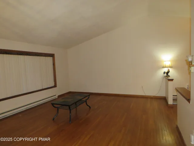 a living room with table furniture and a window