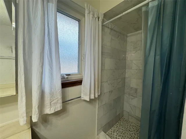 a bathroom with a walk in closet and a bathroom