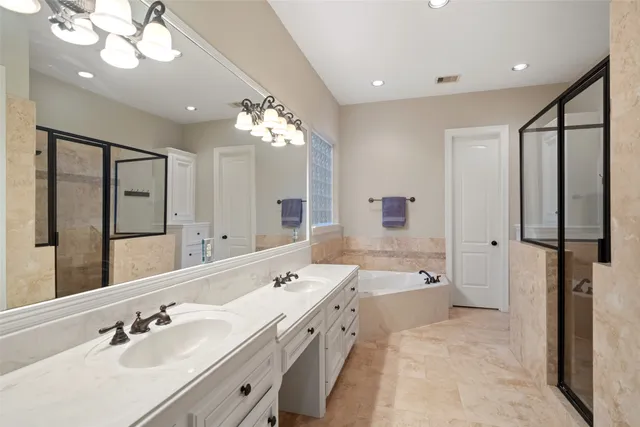 a spacious bathroom with a double vanity sink a mirror and shower