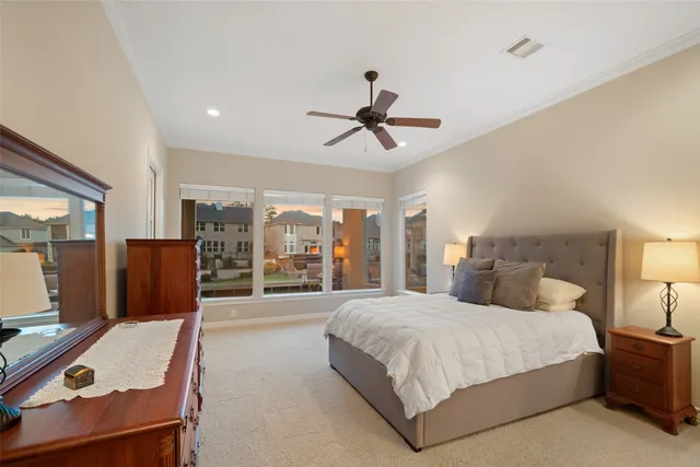 a spacious bedroom with a bed and a chandelier