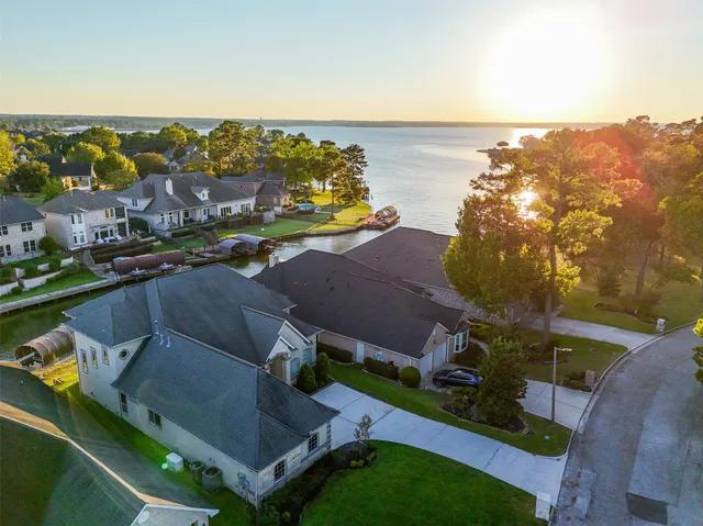 an aerial view of residential houses with outdoor space and ocean view