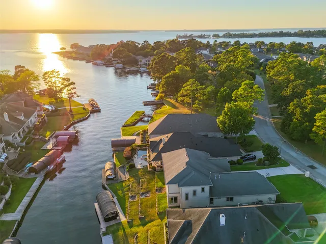 an aerial view of a house with a garden and lake view