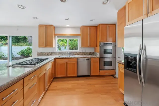 a view of an empty room with a fireplace and a window