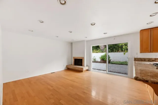a bathroom with a granite countertop sink a toilet a mirror and shower
