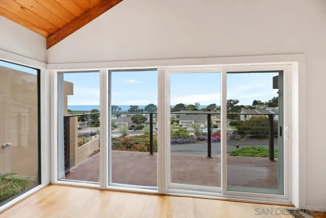 a kitchen with stainless steel appliances granite countertop a refrigerator a stove and a sink with wooden floor