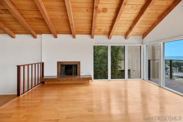 a view of living room with granite countertop furniture and a flat screen tv