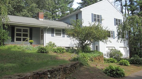 65 Williams Road Concord, MA 01742 - Photo 1 of 15 a front view of a house with garden