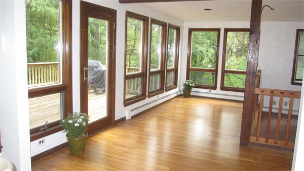65 Williams Road Concord, MA 01742 - Photo 5 of 15 a view of a room with large windows and wooden floor