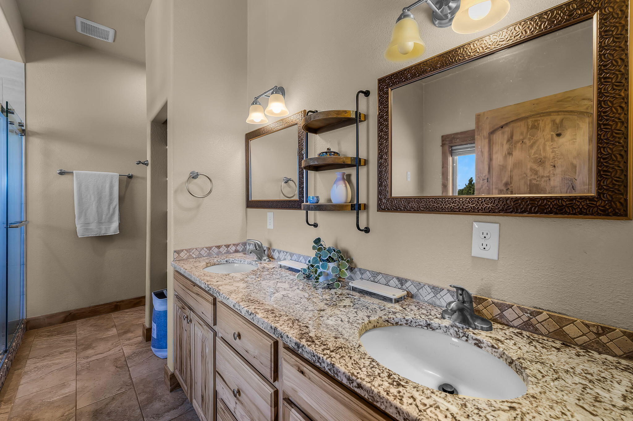 6040 Gravett Road Prineville, OR 97754 - Photo 21 of 77 a bathroom with a granite countertop double vanity sink and mirror
