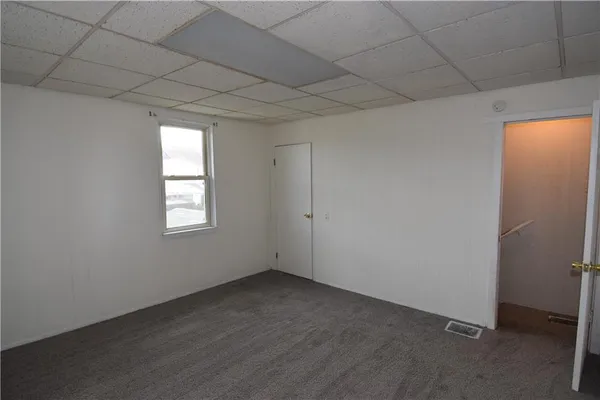 an empty room with a empty space and windows