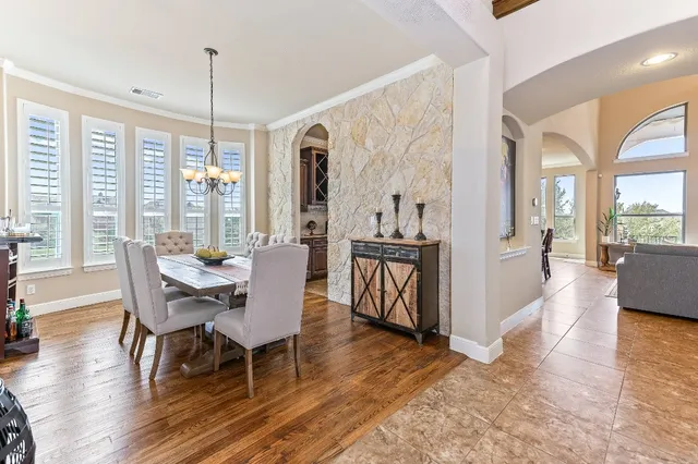 a view of a a dining room with furniture window and wooden floor