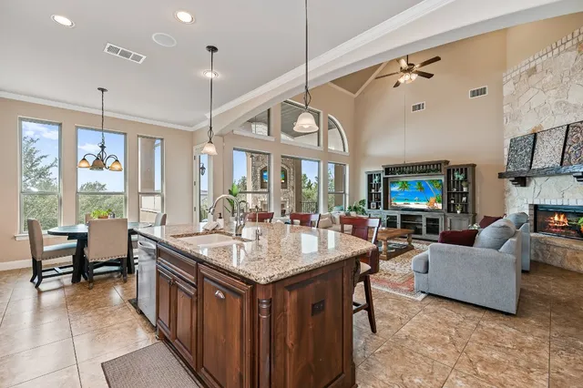 a kitchen with stainless steel appliances granite countertop a refrigerator and cabinets