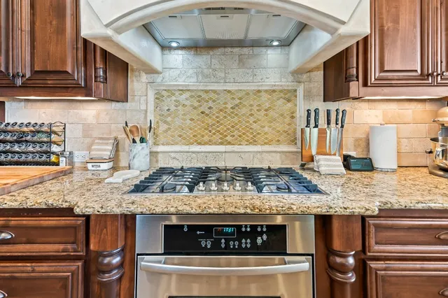 a living room with stainless steel appliances kitchen island granite countertop furniture and a view of kitchen