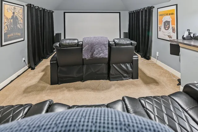 a room with pool table and paintings on the table
