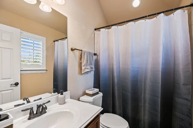 a bedroom with a bed and a lamp