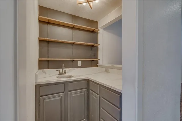 a kitchen with kitchen island a sink and a refrigerator