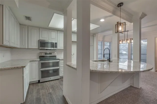 a bathroom with a granite countertop sink a mirror and shower