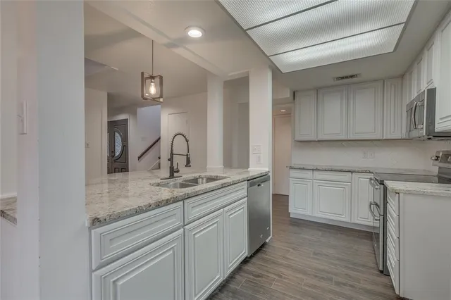 a utility room with sink dryer and washer