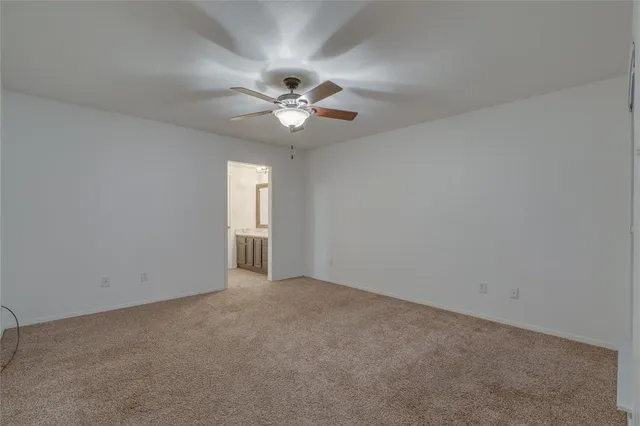 an empty room with a empty space and a ceiling fan