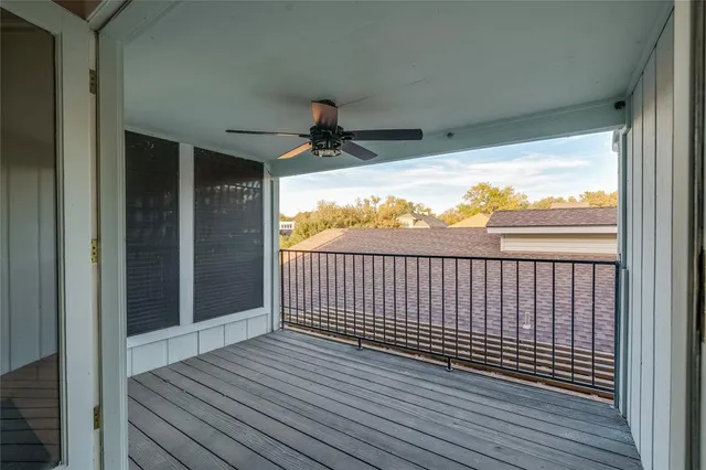 a view of a house with a yard plants and large tree