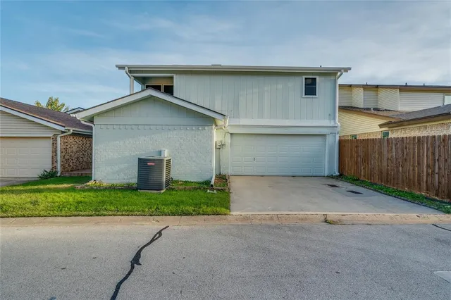 a view of backyard of house and garage