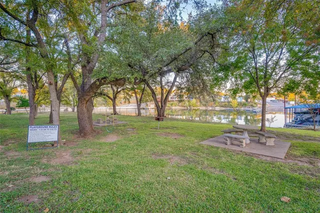 an outdoor view of a house with a lake view