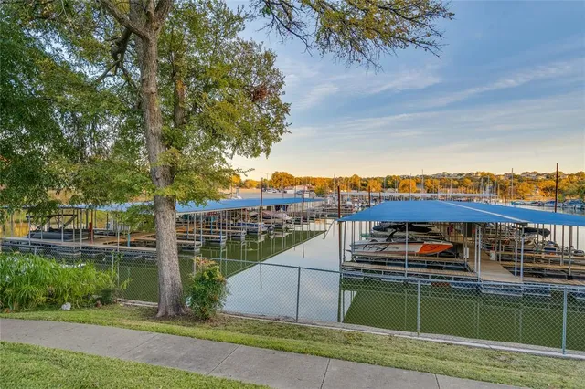a view of a lake with a table and chairs