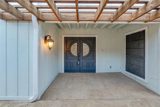 a view of an empty room with a fireplace and a window