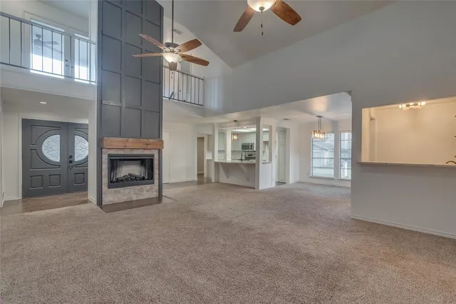 an empty room with fan and windows